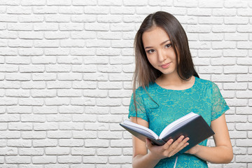 Woman university / college student holding book