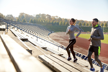 happy couple running upstairs on stadium