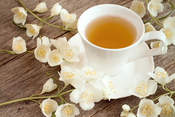 Herbal tea  and blooming flowers