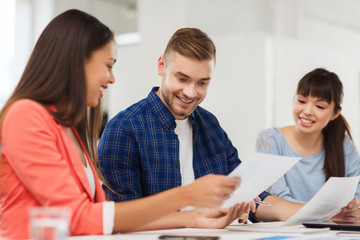 happy creative team or students working at office