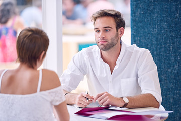 Businessman paying attention to his female partner during business meeting