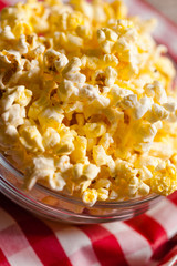 A bowl of popcorn on tablecloth