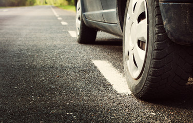 car tires on asphalt road with a dividing line