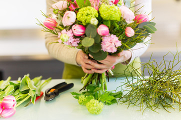 close up of woman making bunch at flower shop