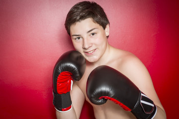 Close-up photo of a boxer with red gloves - obrazy, fototapety, plakaty