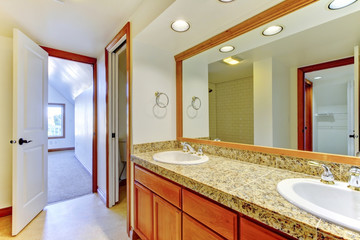 Cozy bathroom with white walls and big mirror