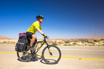 Happy biker relax on beautiful road in Israel desert. Sunny hot day