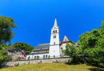 Fototapeta na wymiar Public Neo Gothic Parish Church of Saint Martin at Bled lake in Slovenia on sunny day 