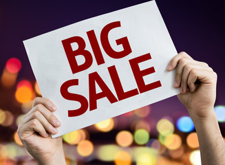 Big Sale placard with night lights on background
