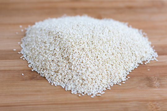 Pile of raw sesame on the wooden board