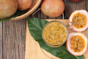 Passion fruit smoothie is delicious on wood background.