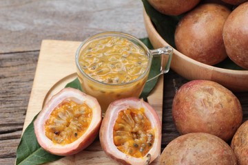 Passion fruit smoothie is delicious on wood background.