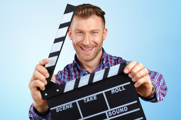 Casual man holding an open movie clap