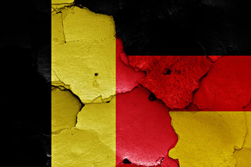 flags of Belgium and Germany painted on cracked wall