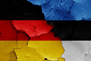flags of Germany and Estonia painted on cracked wall