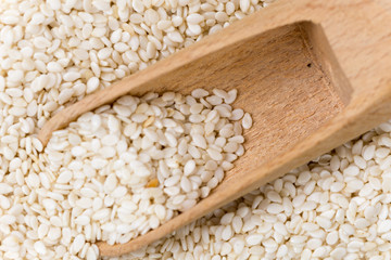 Flat lay wooden spoon raw sesame