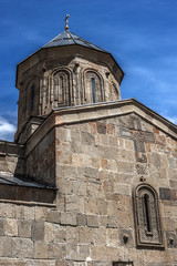 Georgia . Stepantsminda village . Gergeti Sameba Orthodox church on a background of mountain spring .