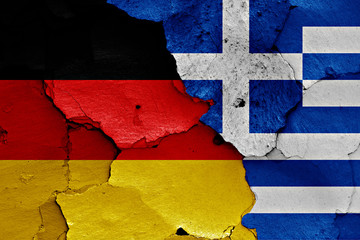 flags of Germany and Greece painted on cracked wall