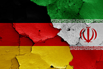 flags of Germany and Iran painted on cracked wall