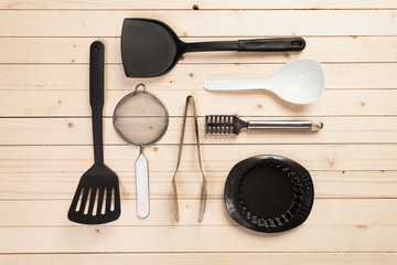 cookware and accessories on a wooden table.