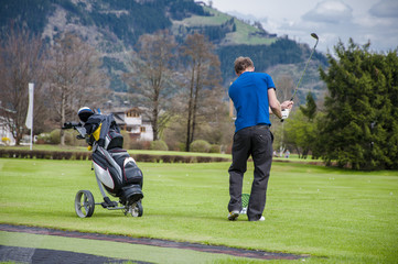 Golfer hitting ball