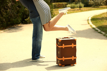 Young couple with vintage suitcase outdoors