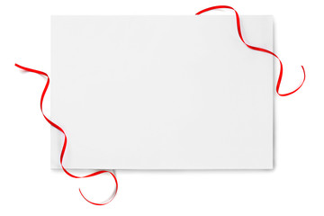 Shiny red ribbon with card isolated on white