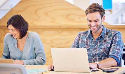 Man and woman hard at work next to each other