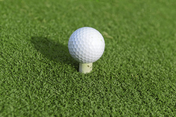 golfball on tee in teebox on golf course