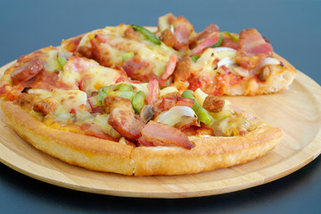 Pizza on a wooden tray.