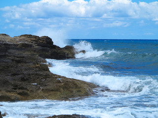 Big waves on rock coast blue sea and sky on Crete