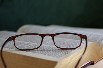 reading glasses on open book 