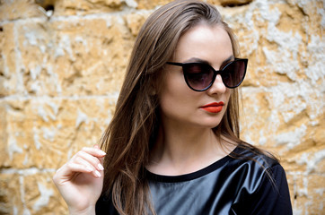 portrait of model posing outdoors in black leather clothes