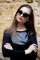 portrait of model posing outdoors in black leather clothes