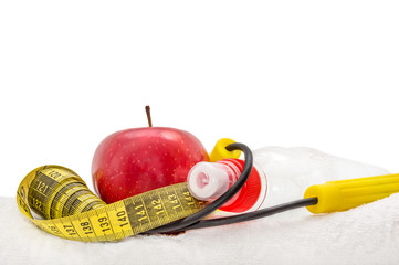 Apple, jump rope, towel, bottle of water and measuring tape isol