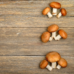 champignon mushrooms on a wooden boards background