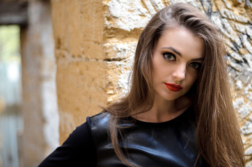 portrait of model posing outdoors in black leather clothes