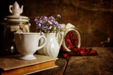retro effect on photo vintage tea with rose dry petal