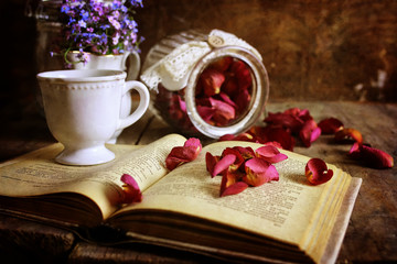 retro effect on photo vintage tea with rose dry petal