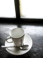 Empty white cup on black floor