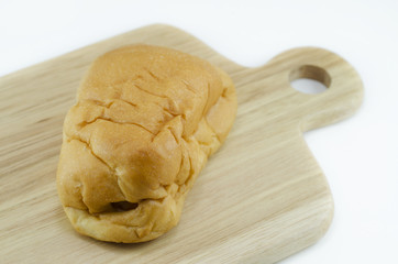 Bread stuffed with sausage on a wooden cutting board