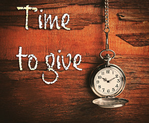 Silver pocket clock on wooden background