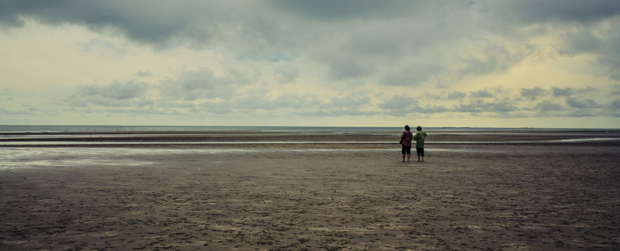 Friends walking on the beach.