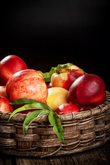 Fresh organic peaches in wooden basket with copy space