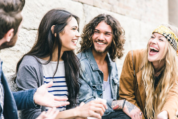 Group of four friends laughing out loud outdoor, sharing good mood - obrazy, fototapety, plakaty