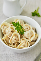 Meat dumplings - russian pelmeni in a bowl.