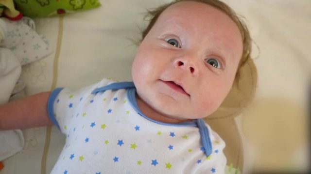 Slow motion shot of a sweet newborn baby lying on back