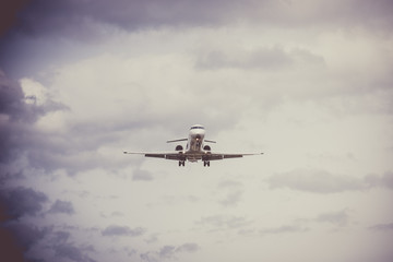 Fototapeta na wymiar Airplane flying with clouds in background