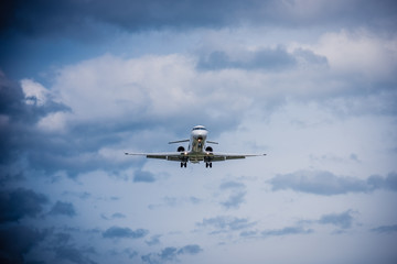 Fototapeta na wymiar Airplane flying with clouds in background