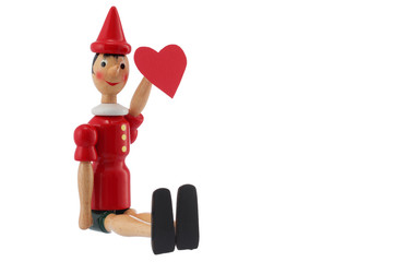 Pinocchio toy statue with heart isolated on white
